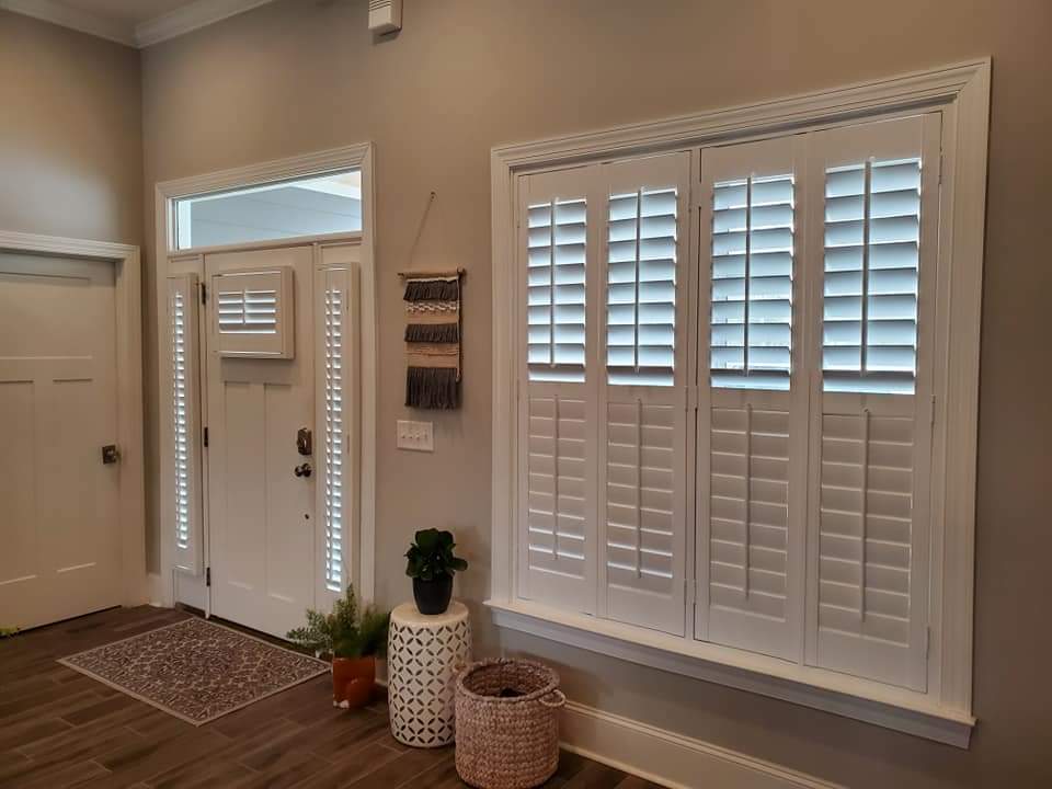 Energy-efficient plantation shutters installed in a modern entryway, enhancing home aesthetics and comfort while contributing to lower energy bills.