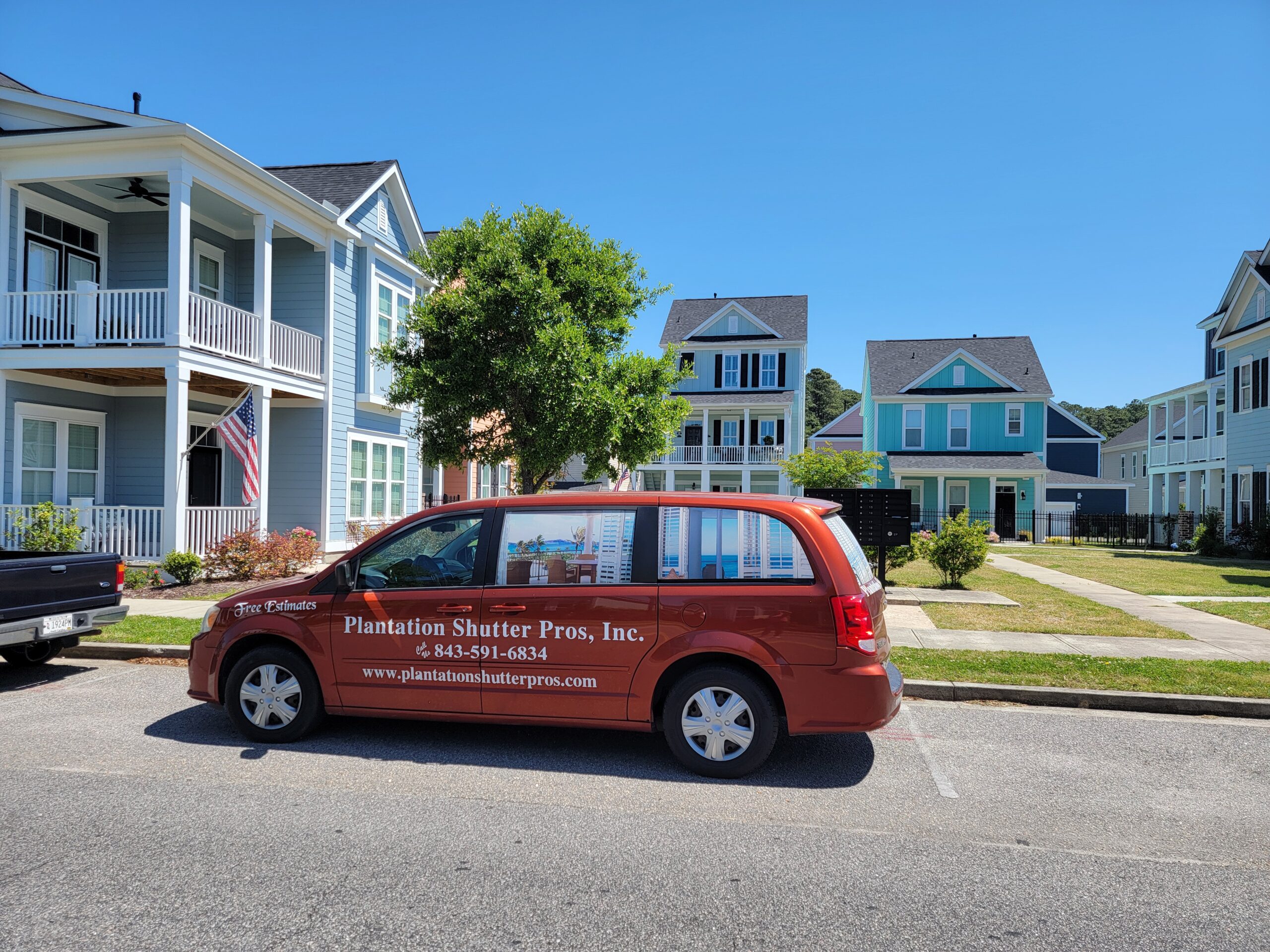Van branded with "Plantation Shutter Pros, Inc." parked in a residential area, showcasing service availability for plantation shutters in Myrtle Beach.